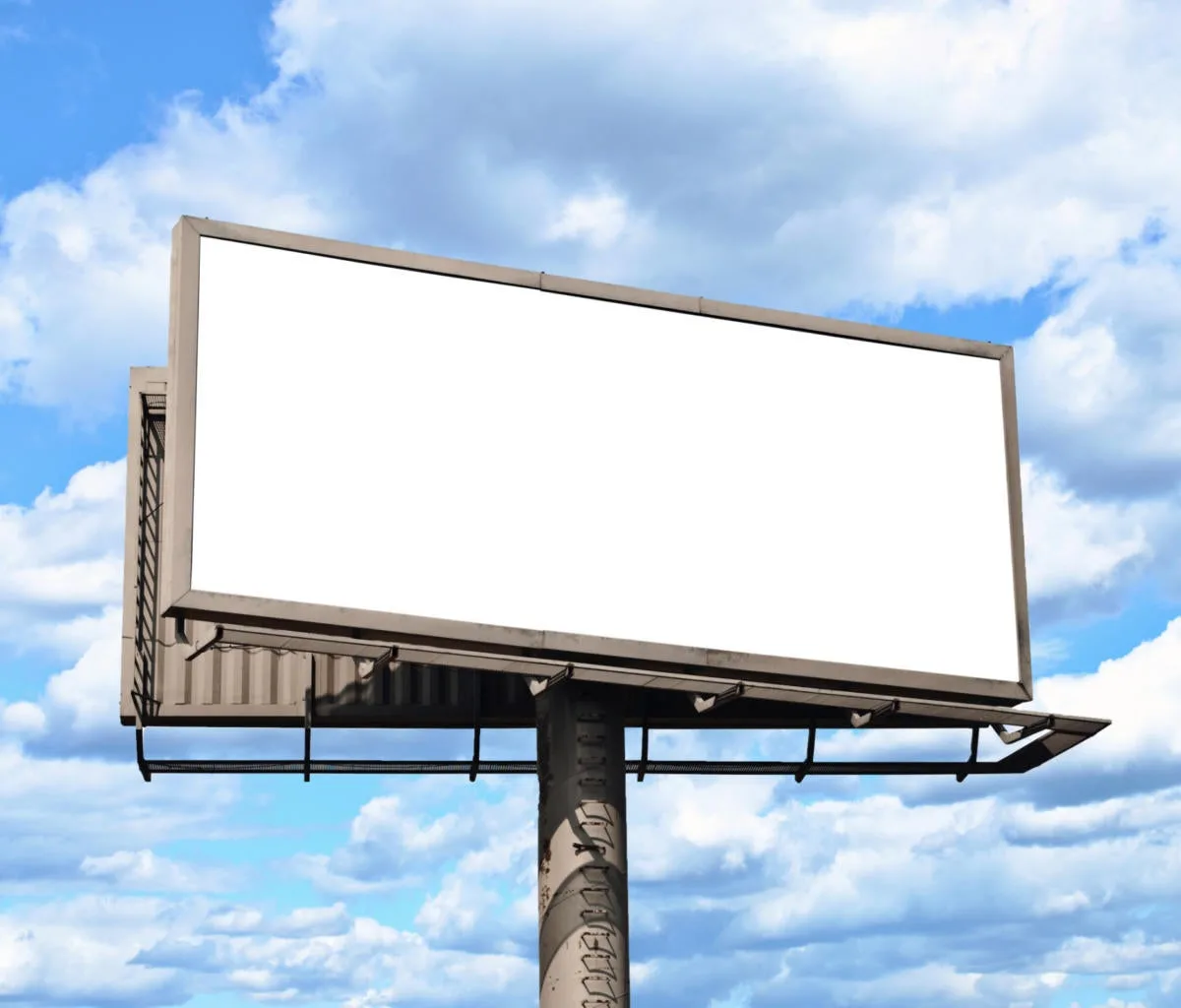 Blank billboard with sky and clouds in the background